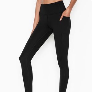 Like new Victoria’s Secret leggings with side pockets and gold emblem